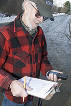 A volunteer recording the location of a road intersection.